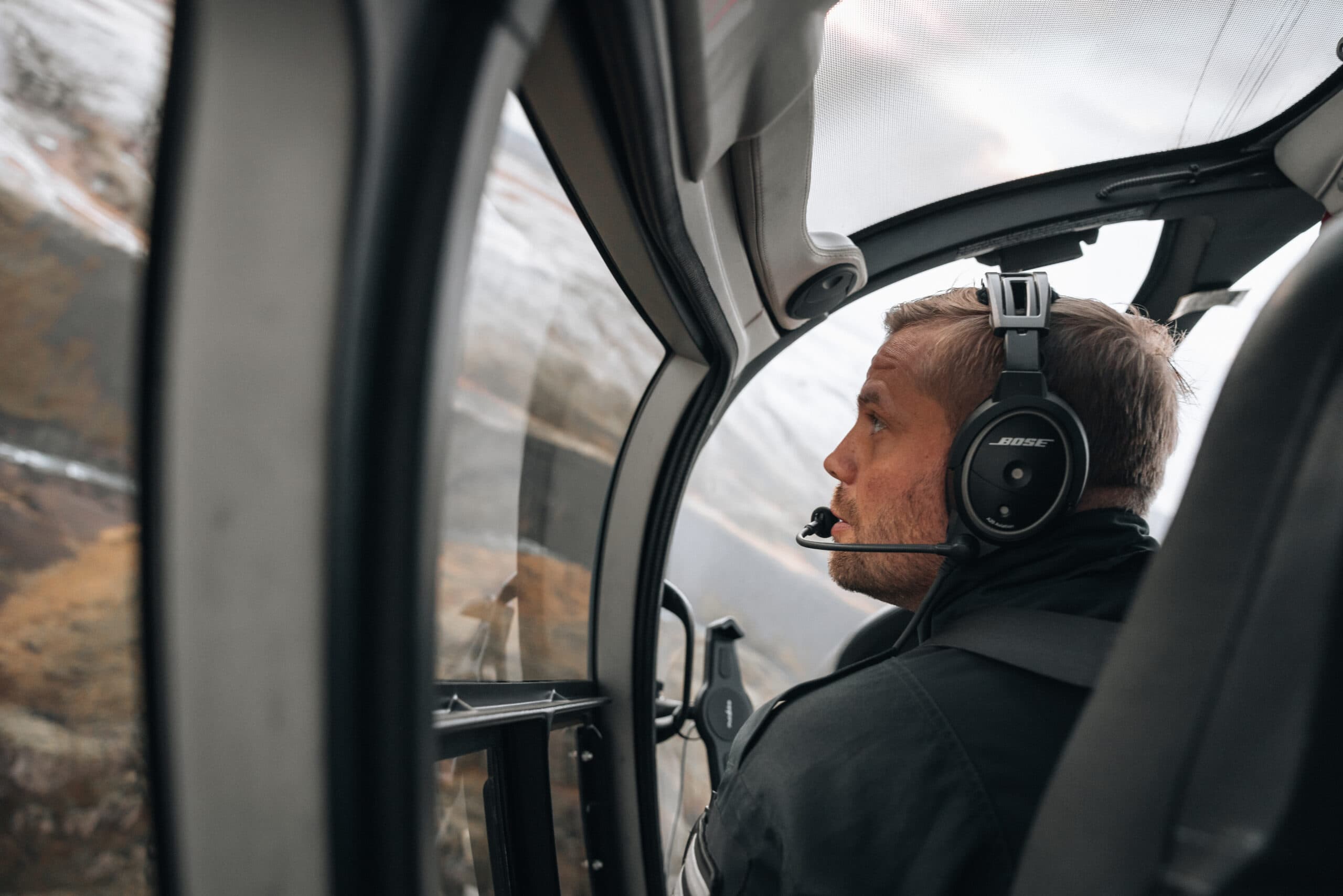 Person taking picture in a helicopter
