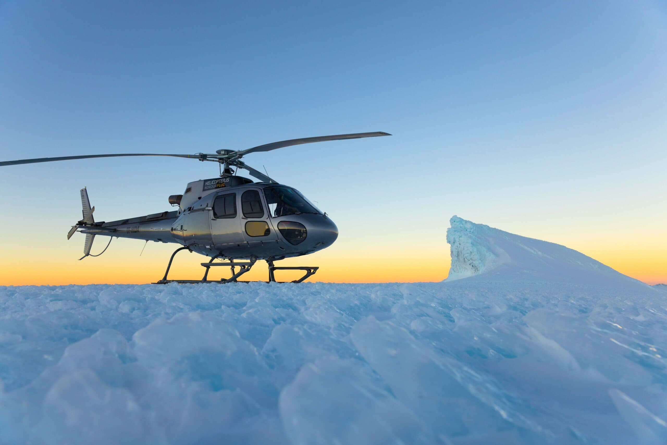 Helicopter flying over a mountain range