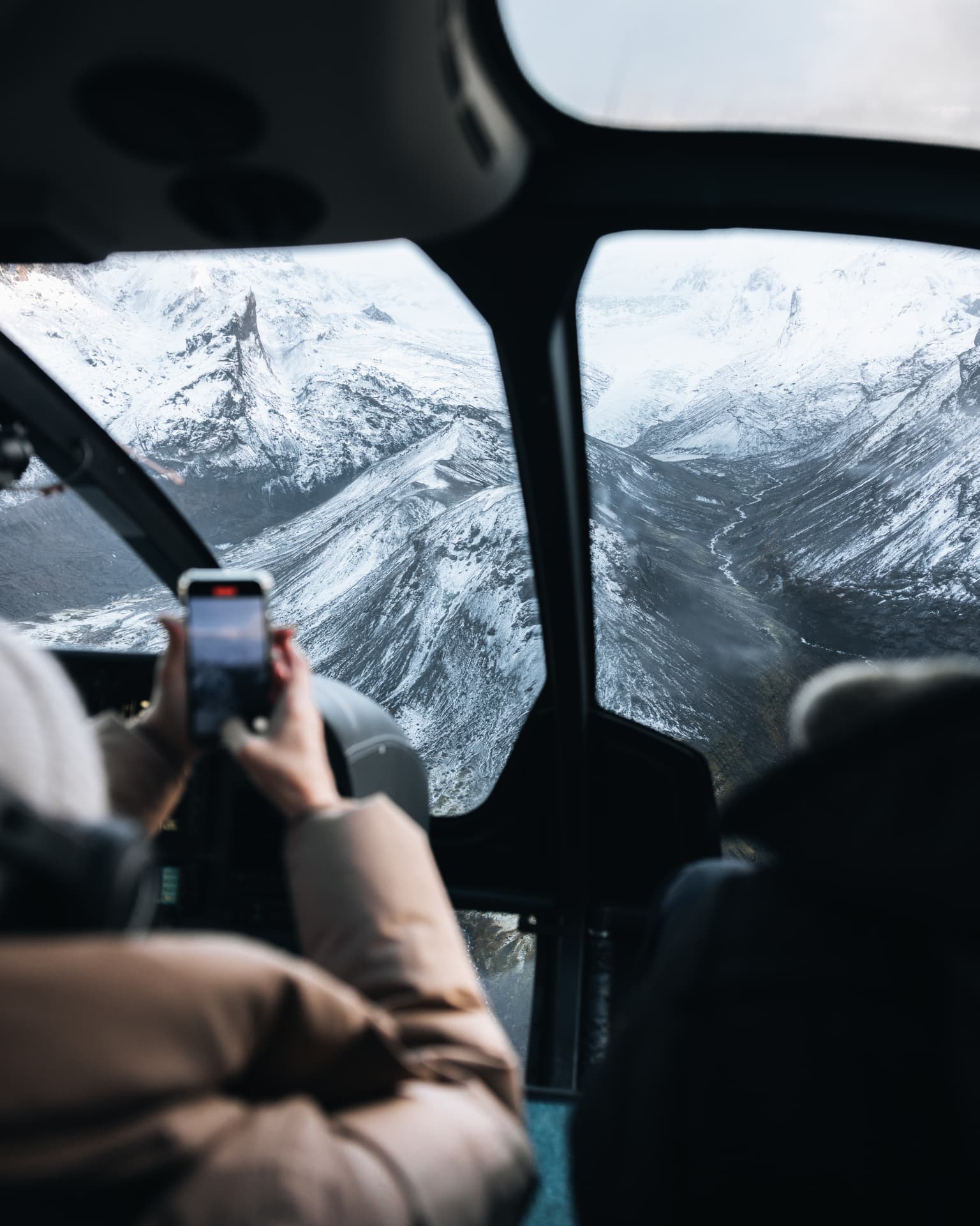 Person taking picture in a helicopter